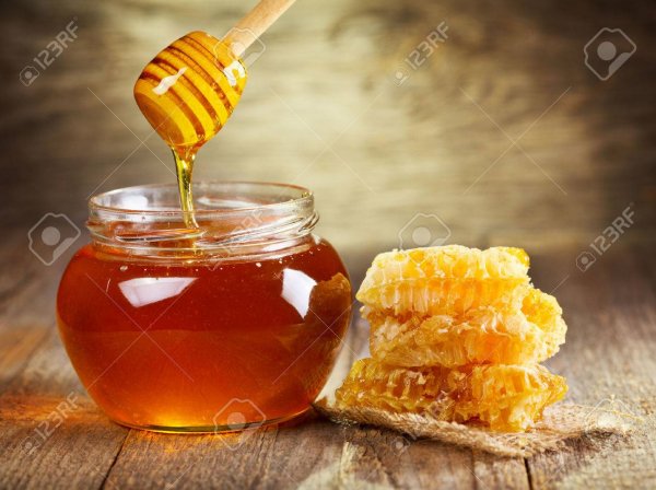 jar-of-honey-with-honeycomb-on-wooden-table-Stock-Ph