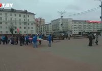 Люди с госсимволикой на площади Победы в Витебске