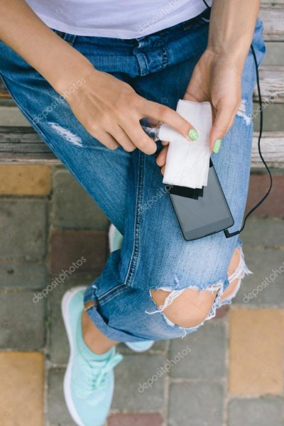 depositphotos 99688566-stock-photo-girl-in-torn-jeans-sitting